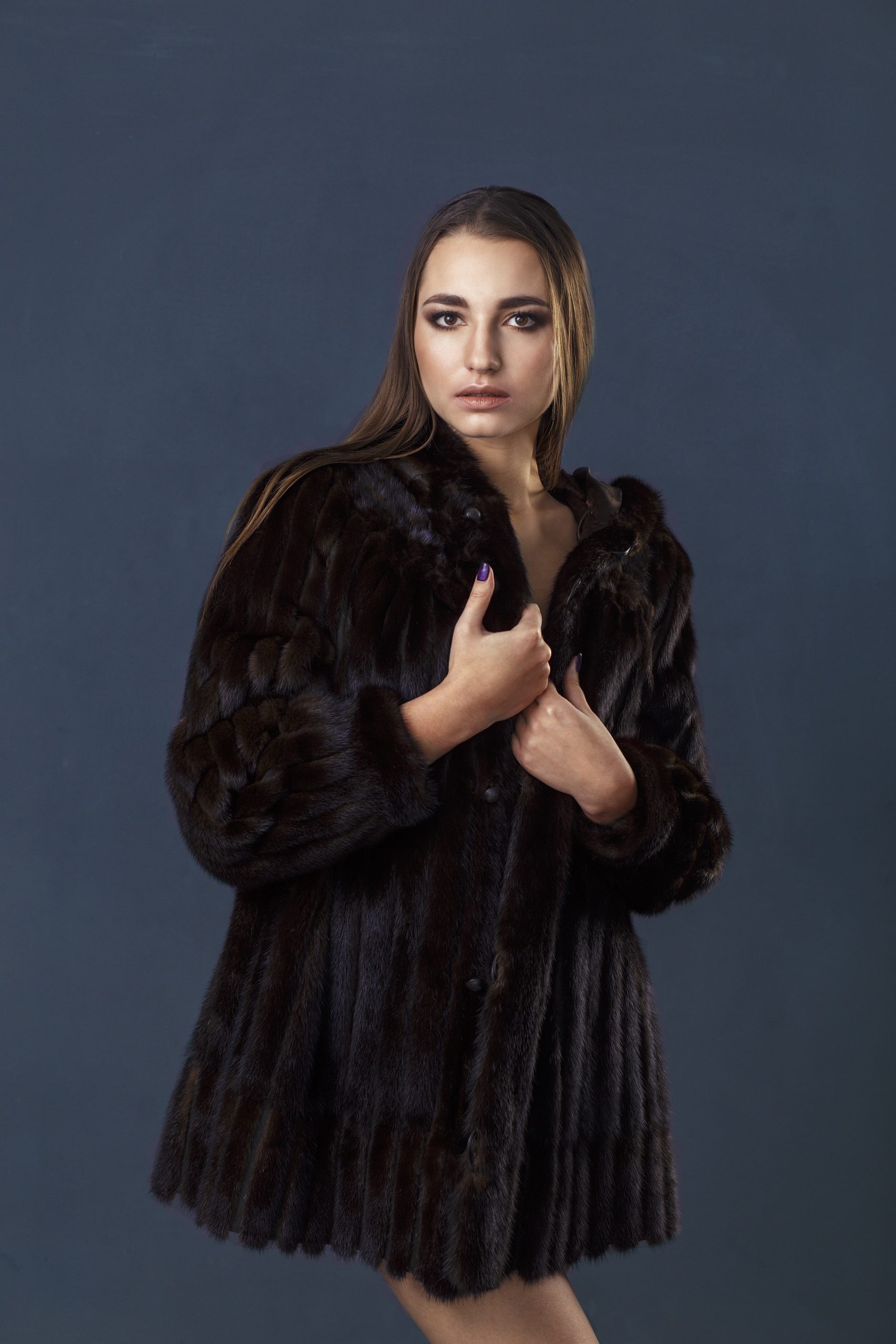 woman poses wearing a stylish dark fur coat 2026 03 19 22 06 49 utc